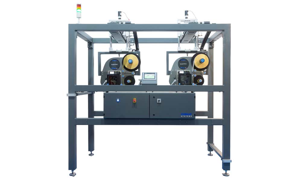 Two integrated print and apply labelling machines in a protective enclosure.